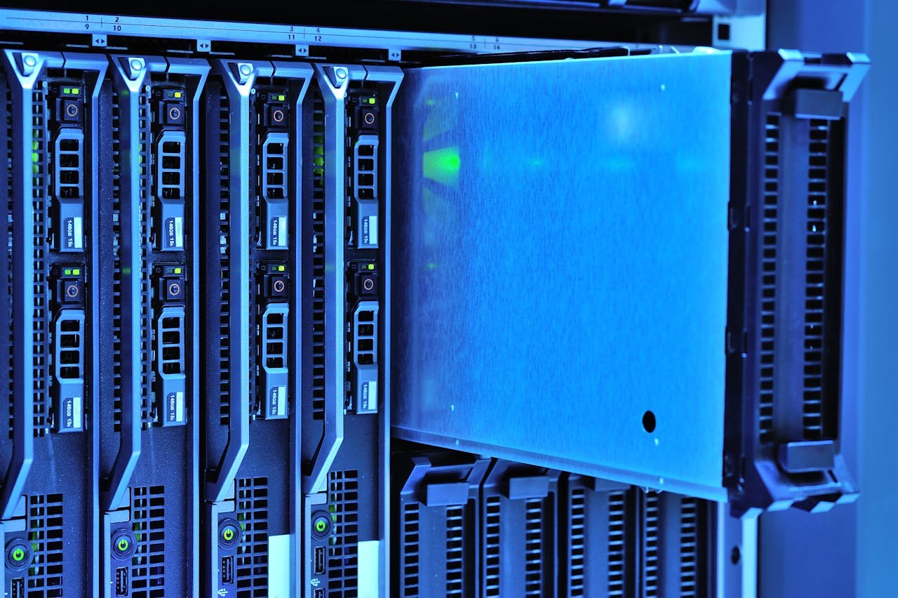 services-01 Detailed view of server racks with glowing lights in a data center environment.