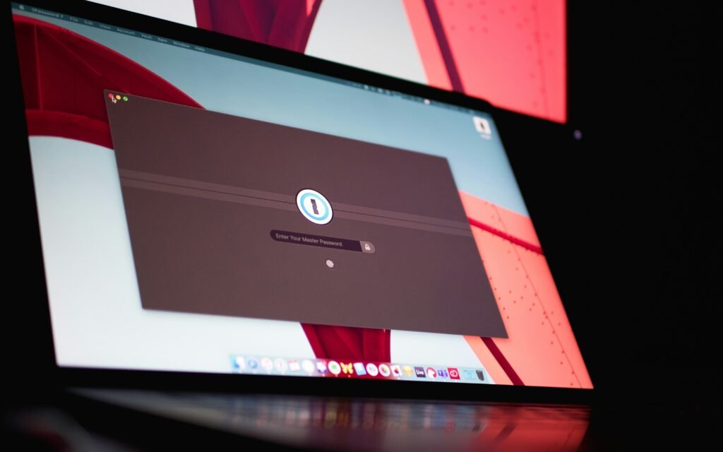 A security engineer's workstation with a laptop and a Synology NAS, symbolizing the shift from cloud-based password managers to locally hosted solutions like Bitwarden.