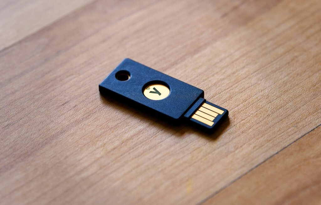 YubiKey for Password Managers: Zero Phishing Attacks at Google Scale—Here's What Actually Works 2 YubiKey 5C NFC hardware security key resting on a laptop keyboard, representing phishing-resistant FIDO2 authentication for password managers like 1Password and Bitwarden.